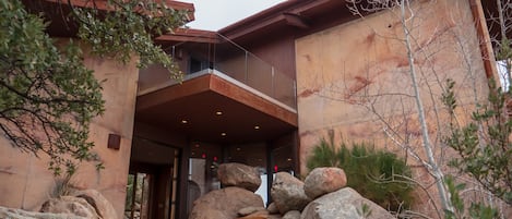 Stairs leading up to the home, waterfall flowing, boulders all around!