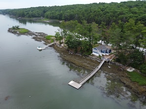 An aerial view of the cottage and dock.