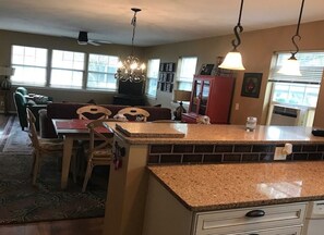 Living room view--large eating table for 6, sleep sofa and sitting area with TV