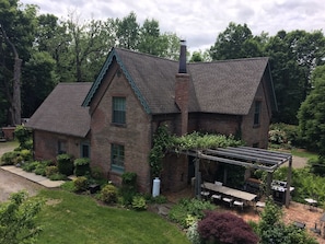 View of house exterior and brick patio.