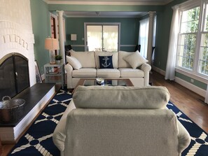 View from side of living room, into dining room and sun room.