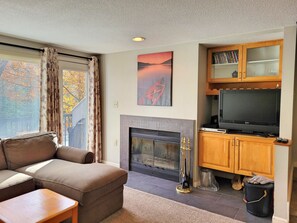 Fireplace, TV and door to balcony