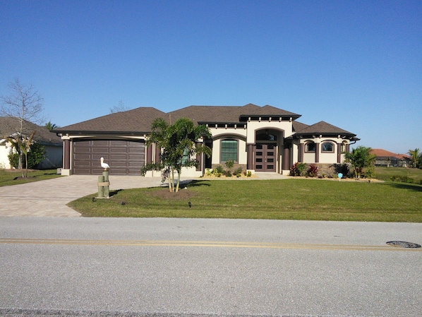 Beautiful 3 BR 3 BR 3 car garage on the canal. Golf course behind this house.