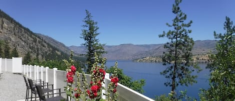 Seats wait for you by the lake so blue.  Come, relax unwind, with peace of mind.