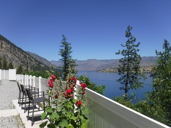 Seats wait for you by the lake so blue.  Come, relax unwind, with peace of mind.