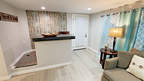 Living Room with wall mounted Cable TV, comfy Down Feather Sofa, Pottery Barn coffee table, and end table;
Bar area is a great place to sit for meals, stools are inside the counter area.
