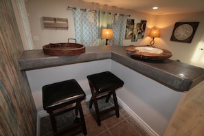 Bar and dining area is a great place to sit for meals, stools are inside the counter area.