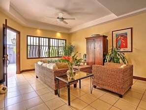 The living area features large screen flat TV and comfortable seating.