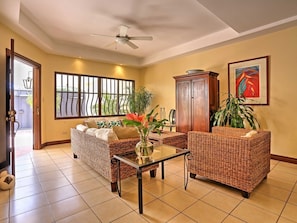 The living area features large screen flat TV and comfortable seating.