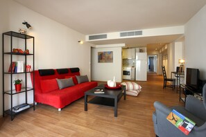Living area, kitchen and corridor leading to the entrance