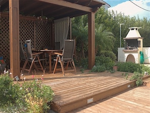 Gazebo with dining table and bbq