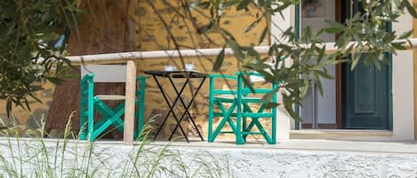 The apartment's patio is hidden in the olive trees