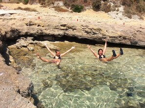 Happy guests are sunbathing in cute lagoon. Spartia Kefalonia Greece vacations