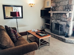 Comfortable living room with gas fireplace and flat screen TV. 