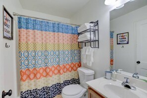 full-size bathroom with tub and all the essentials (shampoo, soaps, and towels)