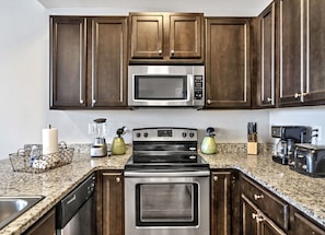 From our kitchen enjoy meal prepping on large expansive granite counter tops w/ views of the ocean sparkling through the window. Pantry provides storage for you food and in-door ice & water dispenser provides the convenience you want at the beach.