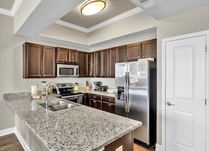 From our kitchen enjoy meal prepping on large expansive granite counter tops w/ views of the ocean sparkling through the window. Pantry provides storage for you food and in-door ice & water dispenser provides the convenience you want at the beach.