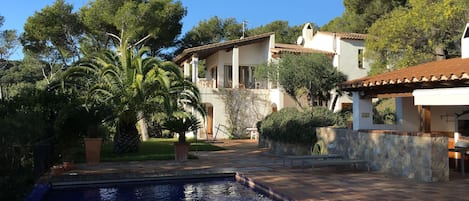 The pool and the pool-house to the right, and the Villa in the background