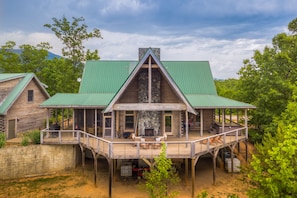 Amazing shot of back of house showing deck and  hot tub area