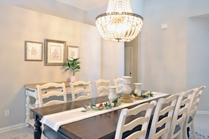 Well-lit formal dining room for eight