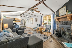 Living room with water views. Wood burning fireplace in addl to central heat/ac.