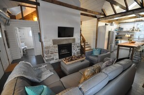 Interior sitting area and kitchen under exposed beams