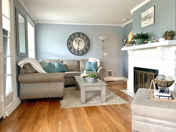 Living room with comfortable sectional and ample seating. 