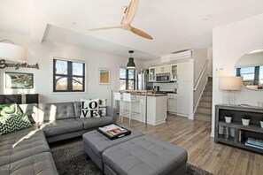 The living space opens to bar top and kitchen.