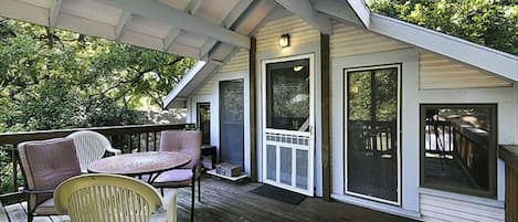 Private entrance to the large deck, with chairs and a table and many trees!