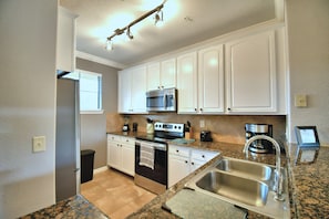 New stainless steel appliances, granite countertop, and beautiful white cabinets