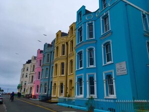 Yellow house is were the flat is situated, across the road is the sea