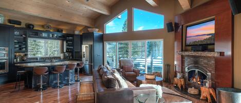 Living room with fireplace and nearby kitchen: Eagle's Nest Lodge