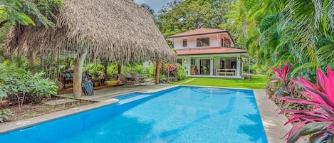 Large private pool and rancho with lush landscape