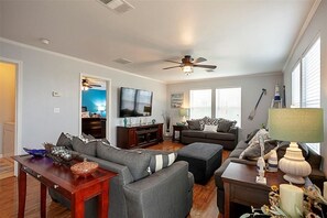 Large living room with lots of seating. Sleeper sofa and 70” TV to Netflix binge