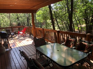 Back deck has outdoor seating for six people and a barbecue