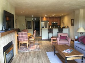 Living room with fireplace and view of kitchen