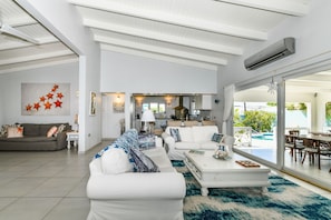 Step Into this open living area over looking the lanai and lighted pool.