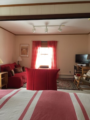 view of room from King Bed, TV on right. Two fold outs in red.