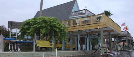 Sandpiper's Song is on canal with large bulkhead, dock ladder, decks and swings.