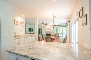 This home receives lovely natural light through its many windows and sliding glass doors.