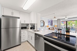 Spacious open kitchen with modern appliances and dining essentials