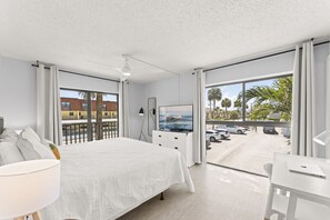Bright and airy master bedroom with floor-to-ceiling windows and a private balcony