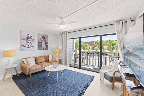 Family room with a 65" TV & balcony access