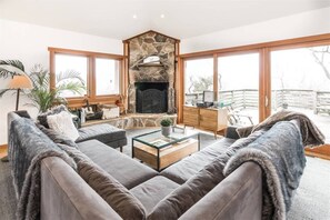 Upstairs open living room with rustic fireplace. Retro record player and albums.