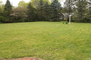 Large, flat backyard perfect for kickball games