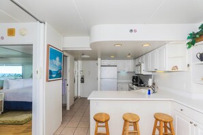 The open kitchen with full appliances will make preparing meals like you were at home