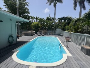 Dive into relaxation with your private pool and hot tub, surrounded by lush tropical greenery