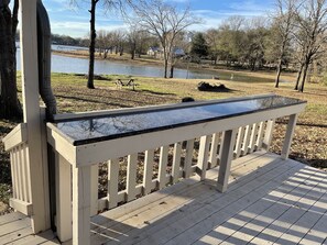 Additional uncovered deck for cooking with bar and 4 bar stools.