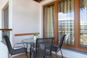A private balcony with a small table and chairs, an ideal spot for enjoying coffee or relaxing outdoors.