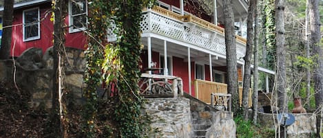 Front of the cabin showing terraced seating areas and porch on second level.